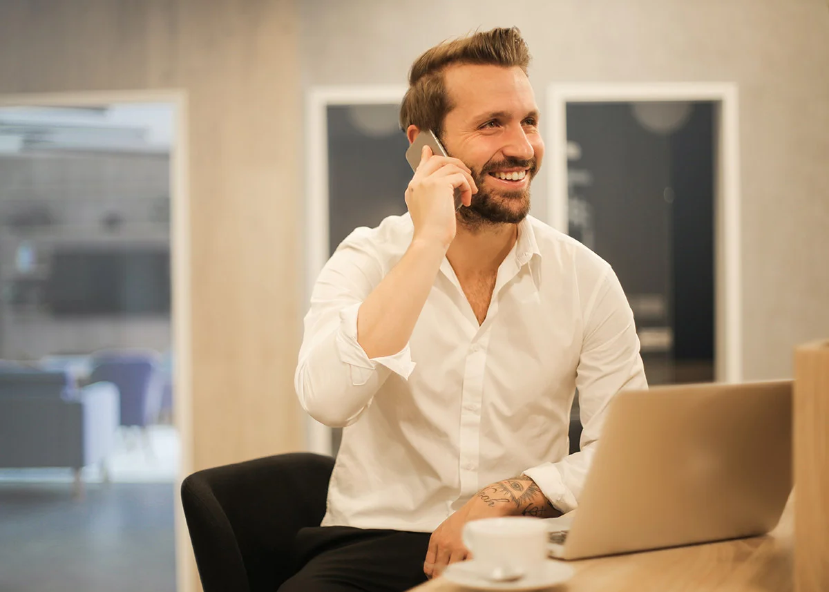 Man on a business call at the office with a laptop